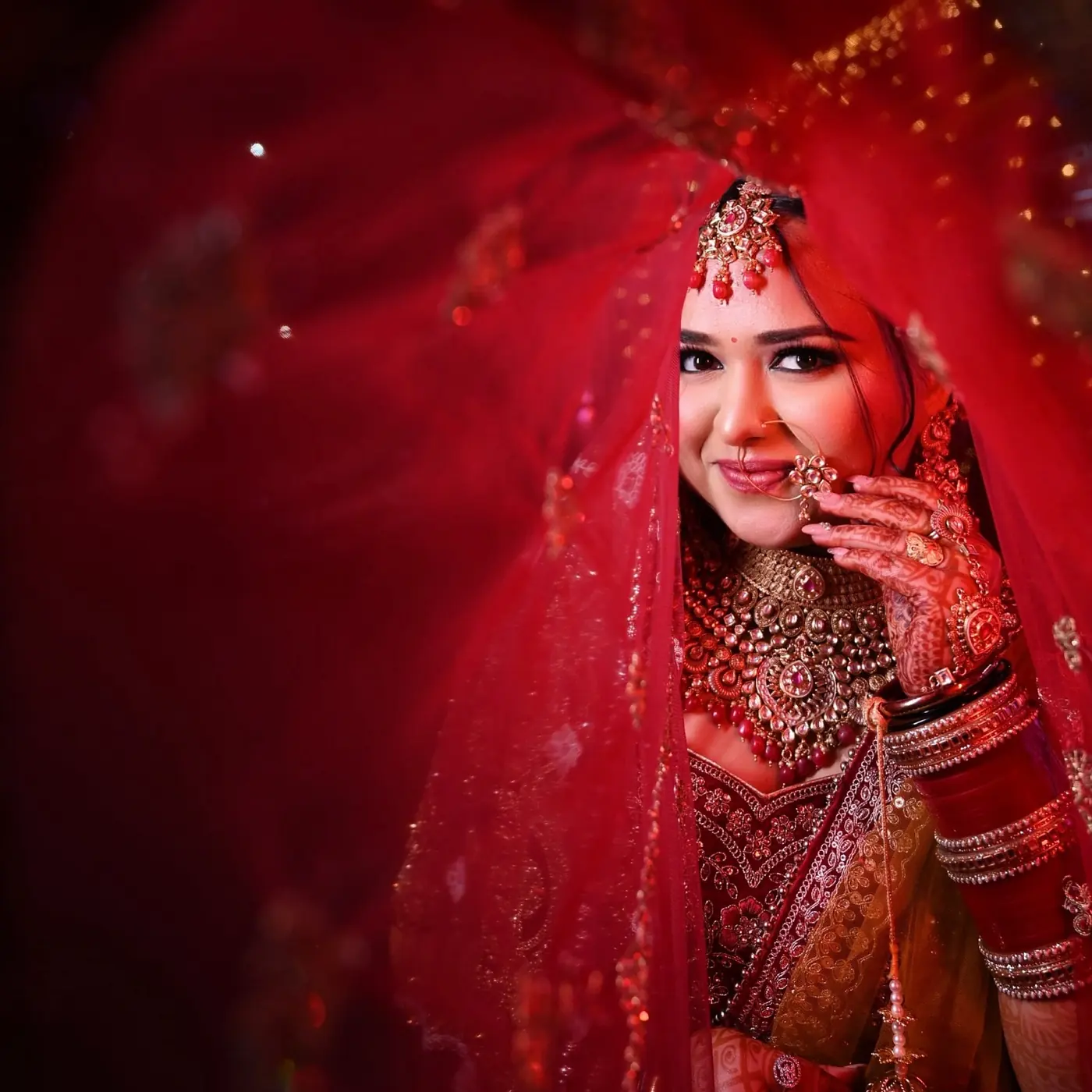 Red Veil, Soft Smile. Bridal makeup by Madhu Gupta at MG Makeovers, Gurugram